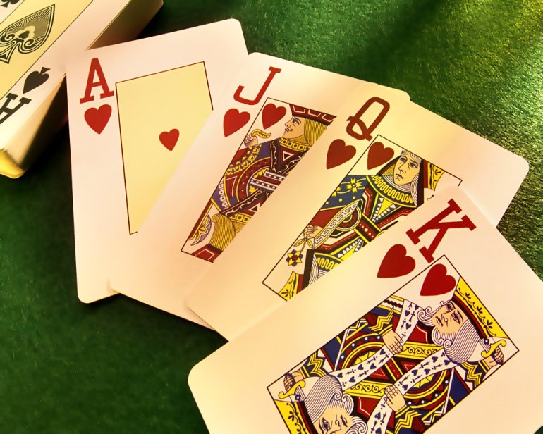 A deck of cards on the table in the casino, separately lie ACE, Jack, Queen and king