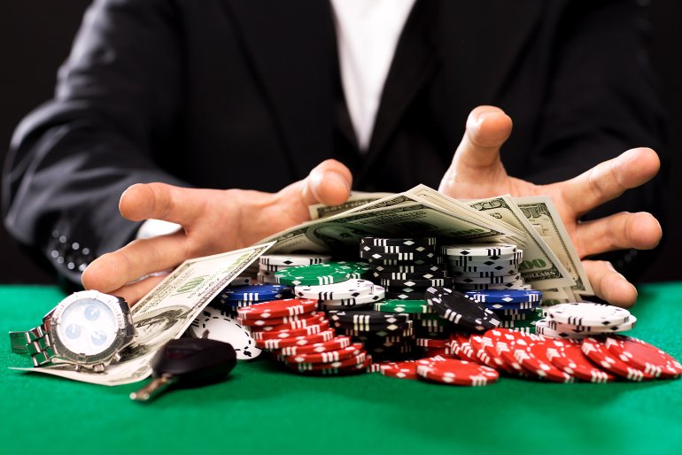 Money and chips in the hands of the casino client
