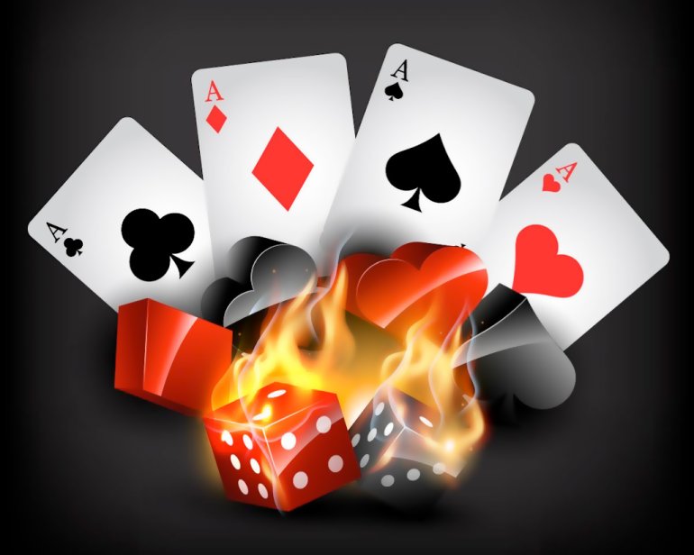 Four aces and dice on fire on a black background