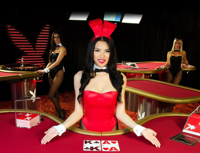 A girl in a red playboy suit works as a dealer in a casino