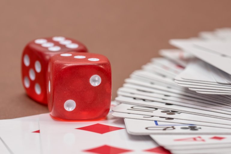 playing cards and red dice