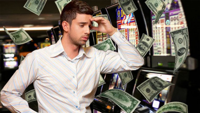 A Guy near Slot Machines against the Background of Flying Dollar Bills
